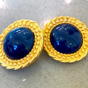 Gold satin metal with swirled navy lucite navy centers. Round dome Earrings clip